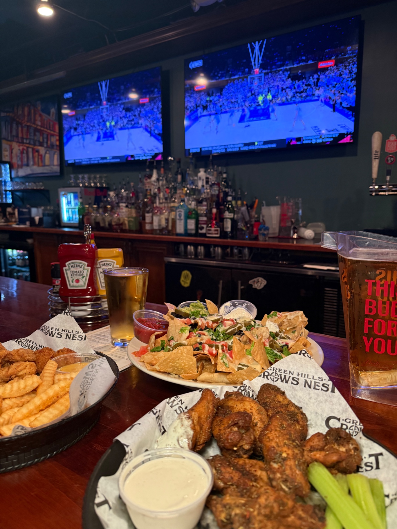 Wings, nachos and cold beer beneath the sports TVs at Crow's Nest